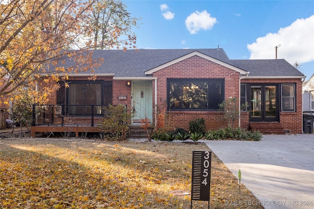 view of front of home with french doors and a front yard