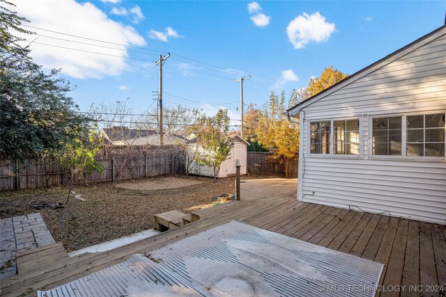 wooden deck featuring a storage unit