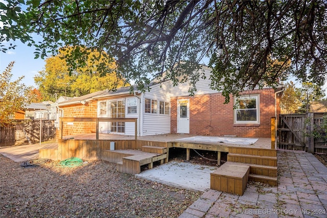 back of property with a wooden deck