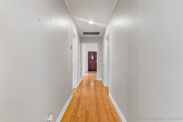 corridor with light hardwood / wood-style flooring