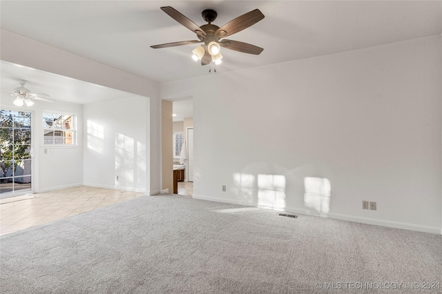 unfurnished room featuring ceiling fan and light colored carpet