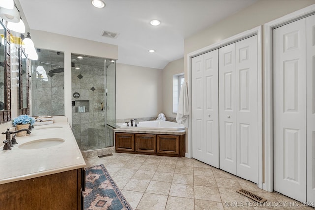 bathroom with plus walk in shower, vanity, and tile patterned floors