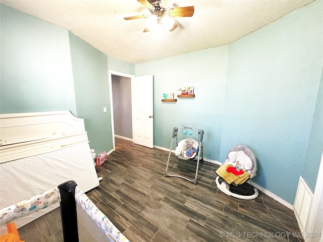 76 N Greer, Eufaula, OK 74432 - bedroom featuring wood finished floors, baseboards, a textured ceiling, and a ceiling fan