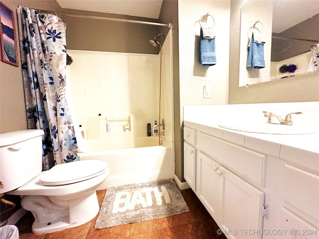 full bathroom with tile patterned flooring, shower / bath combo with shower curtain, vanity, and toilet