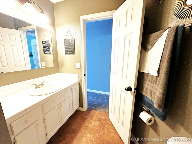 76 N Greer, Eufaula, OK 74432 - bathroom with vanity, a textured wall, and baseboards
