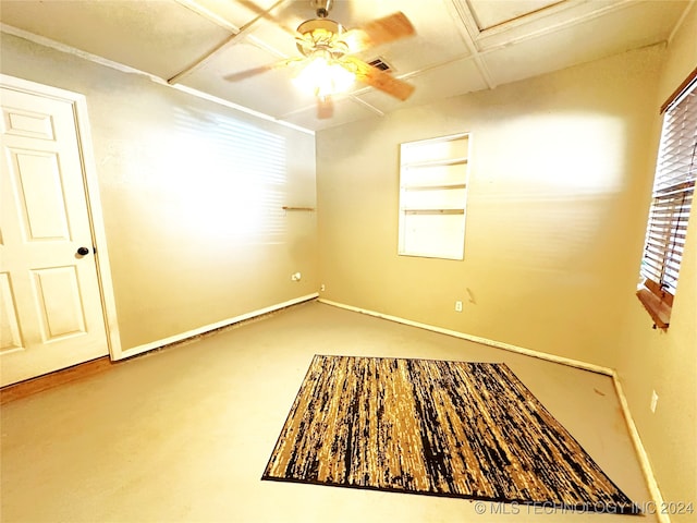 unfurnished room featuring concrete flooring, plenty of natural light, and ceiling fan