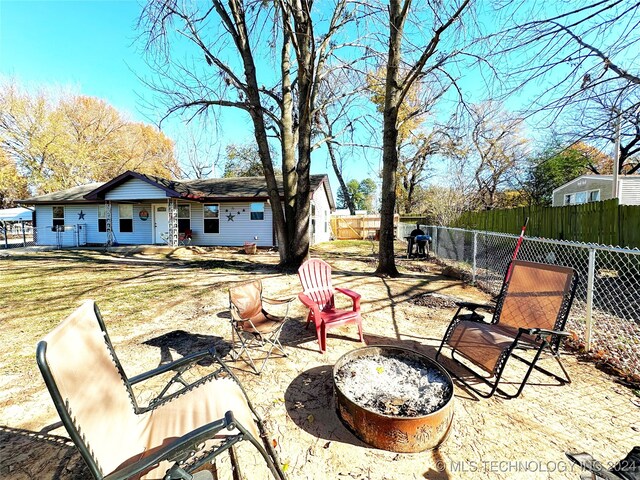76 N Greer, Eufaula, OK 74432 - fenced backyard with an outdoor fire pit and a patio area