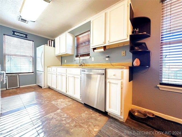 kitchen with a textured ceiling, sink, white refrigerator, dishwasher, and white cabinetry