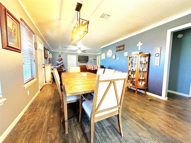 dining room with a textured ceiling, ceiling fan, and dark wood-type flooring