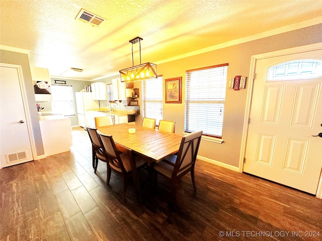 76 N Greer, Eufaula, OK 74432 - dining space featuring wood finished floors, a textured ceiling, crown molding, and baseboards