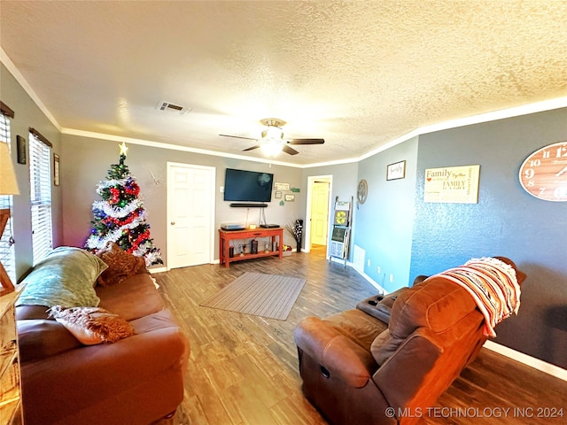 living room with ceiling fan, ornamental molding, a textured ceiling, and hardwood / wood-style flooring