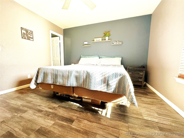 bedroom with ceiling fan and wood-type flooring