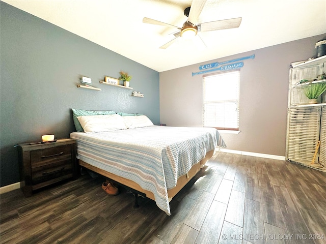 bedroom with dark hardwood / wood-style floors and ceiling fan