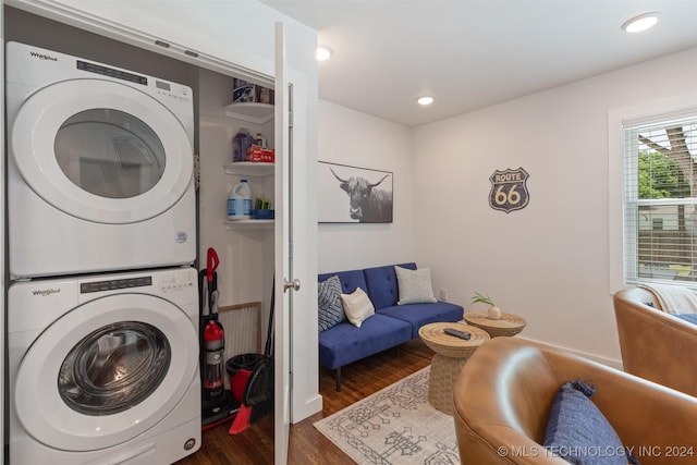 clothes washing area with stacked washer / drying machine and dark hardwood / wood-style flooring