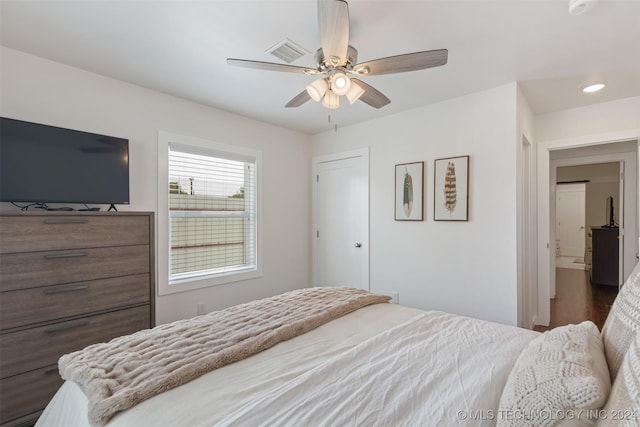 bedroom with ceiling fan and dark hardwood / wood-style flooring