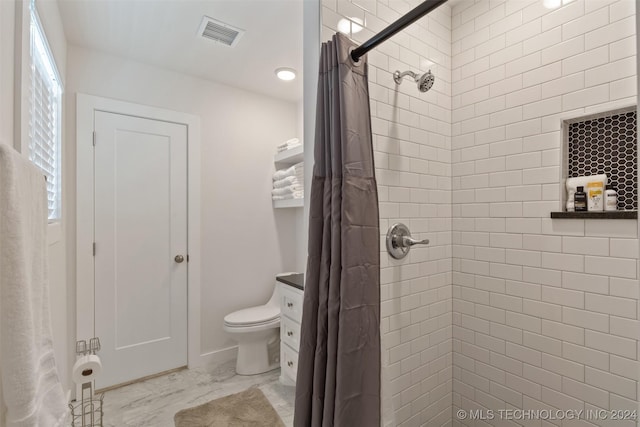 bathroom featuring vanity, toilet, and walk in shower