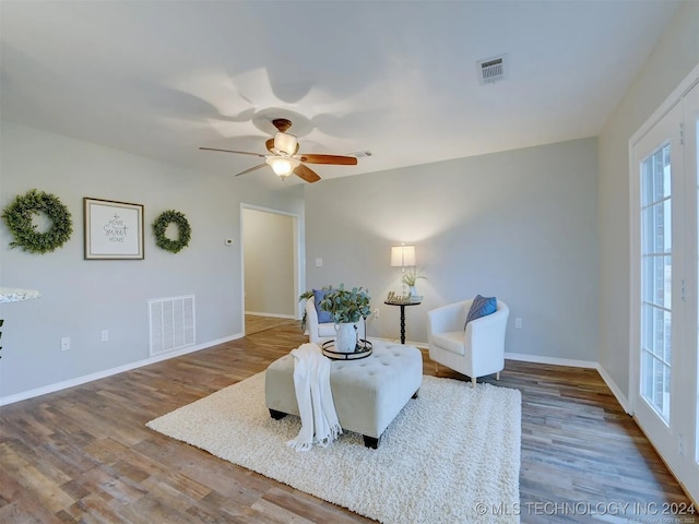 sitting room featuring wood-type flooring and ceiling fan