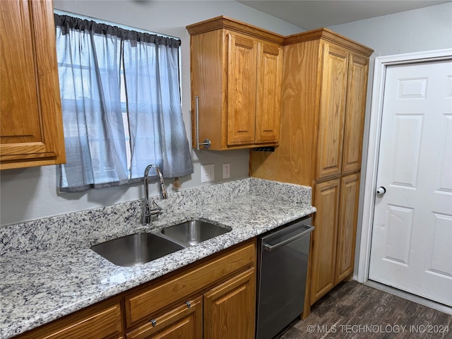 kitchen with stainless steel dishwasher, light stone counters, dark hardwood / wood-style flooring, and sink