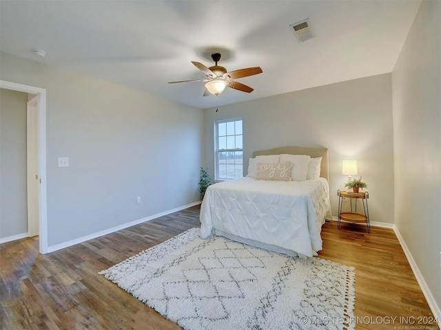 bedroom with ceiling fan and wood-type flooring