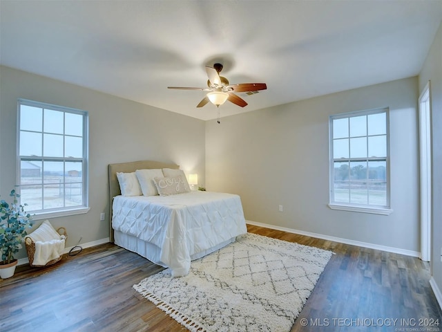 bedroom with ceiling fan and dark wood-type flooring