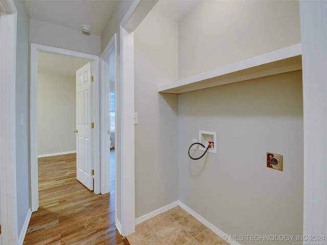 clothes washing area with washer hookup, light hardwood / wood-style floors, and electric dryer hookup