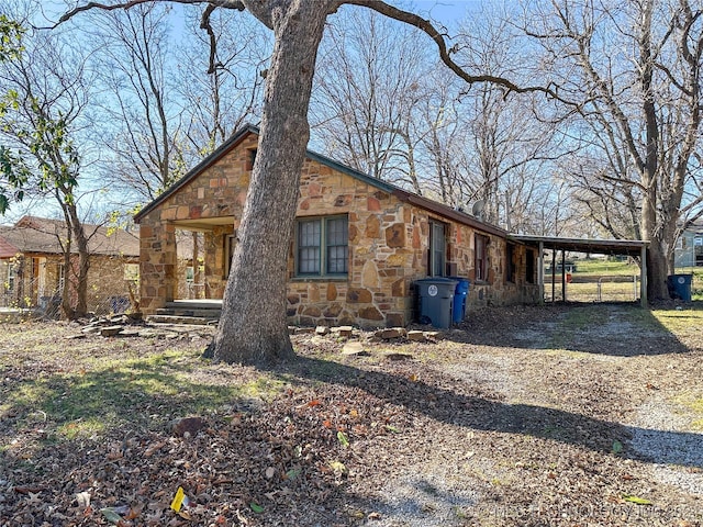 view of side of property with a carport