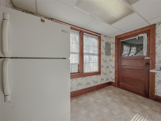 doorway to outside with a paneled ceiling and electric panel