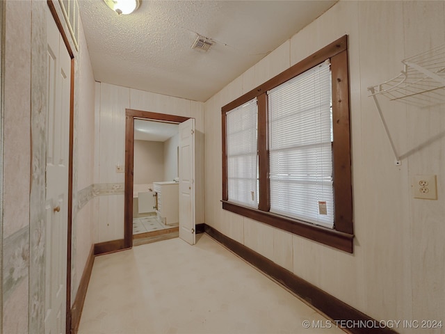 hallway featuring a textured ceiling