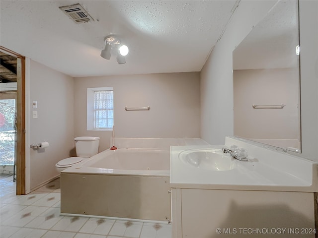 bathroom with tile patterned flooring, vanity, toilet, and a tub