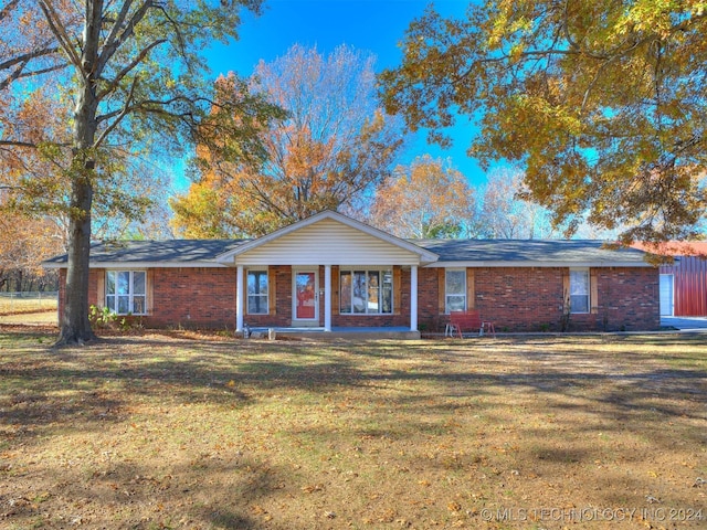 ranch-style house with covered porch and a front yard