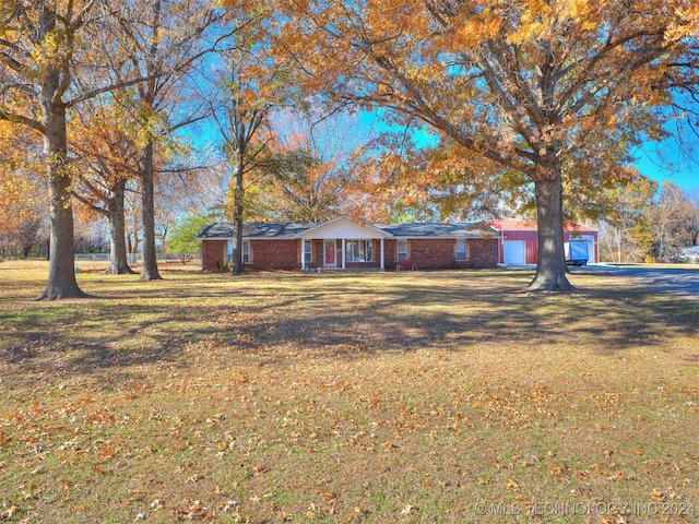 ranch-style house with a garage and a front yard