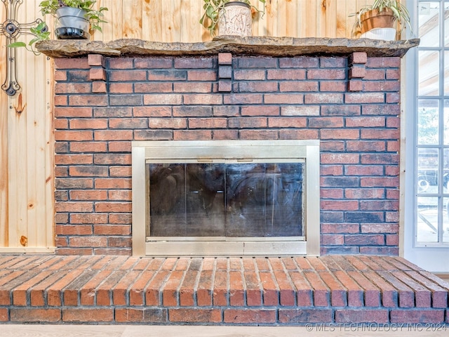 interior details featuring a brick fireplace