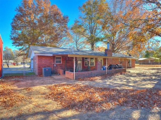 ranch-style home featuring cooling unit and a patio