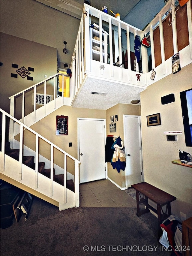 stairway featuring carpet flooring