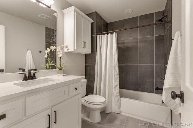 full bathroom with tile patterned floors, shower / tub combo with curtain, vanity, and toilet