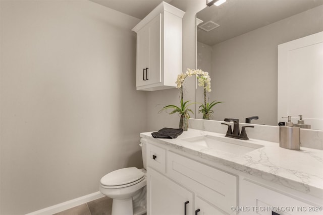 bathroom featuring tile patterned floors, vanity, and toilet