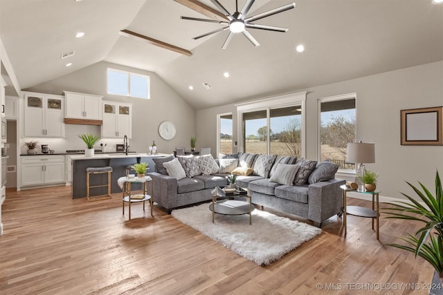 living room featuring ceiling fan, light hardwood / wood-style floors, a wealth of natural light, and sink