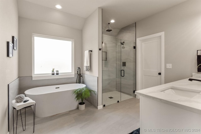 bathroom featuring vanity and shower with separate bathtub