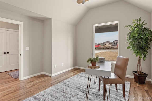 living area featuring light hardwood / wood-style floors and vaulted ceiling