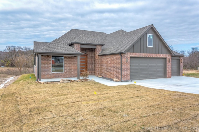 view of front of property featuring a garage and a front lawn