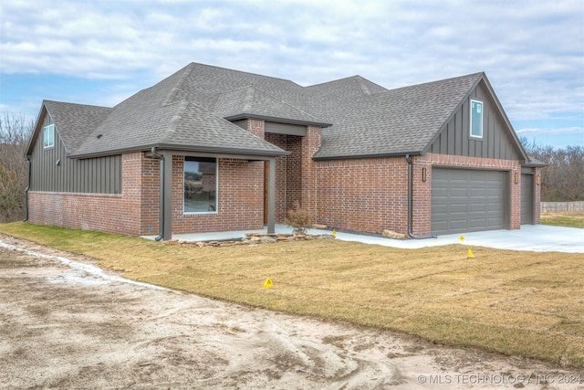 view of front of property featuring a garage and a front lawn