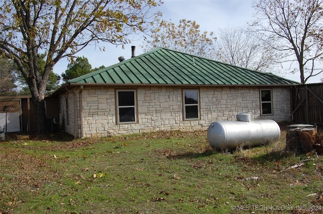 view of side of home with stone siding, metal roof, and a standing seam roof