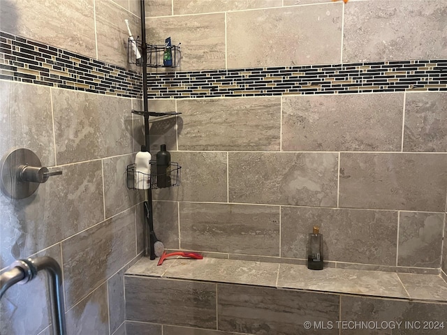 interior details with a tile shower