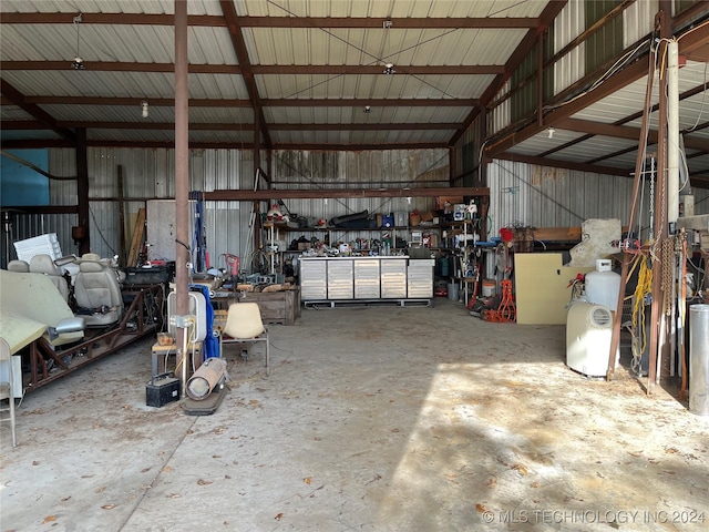 garage with a workshop area and metal wall