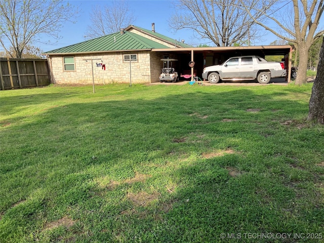 view of yard with fence and an attached carport
