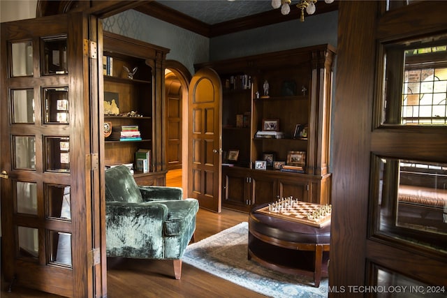 sitting room featuring ornamental molding and light hardwood / wood-style flooring