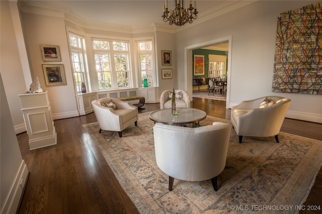 living area featuring a chandelier, hardwood / wood-style flooring, and crown molding