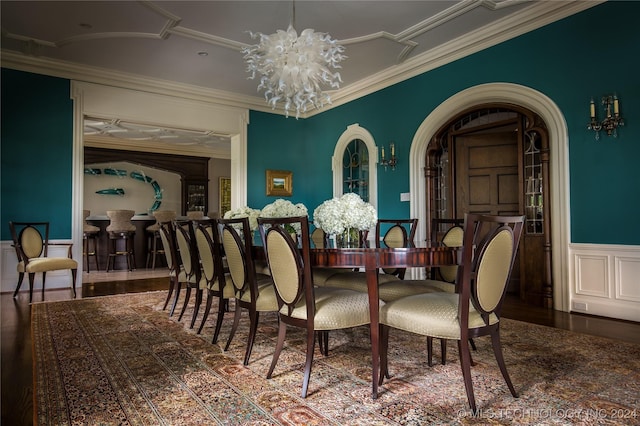 dining area with an inviting chandelier and ornamental molding