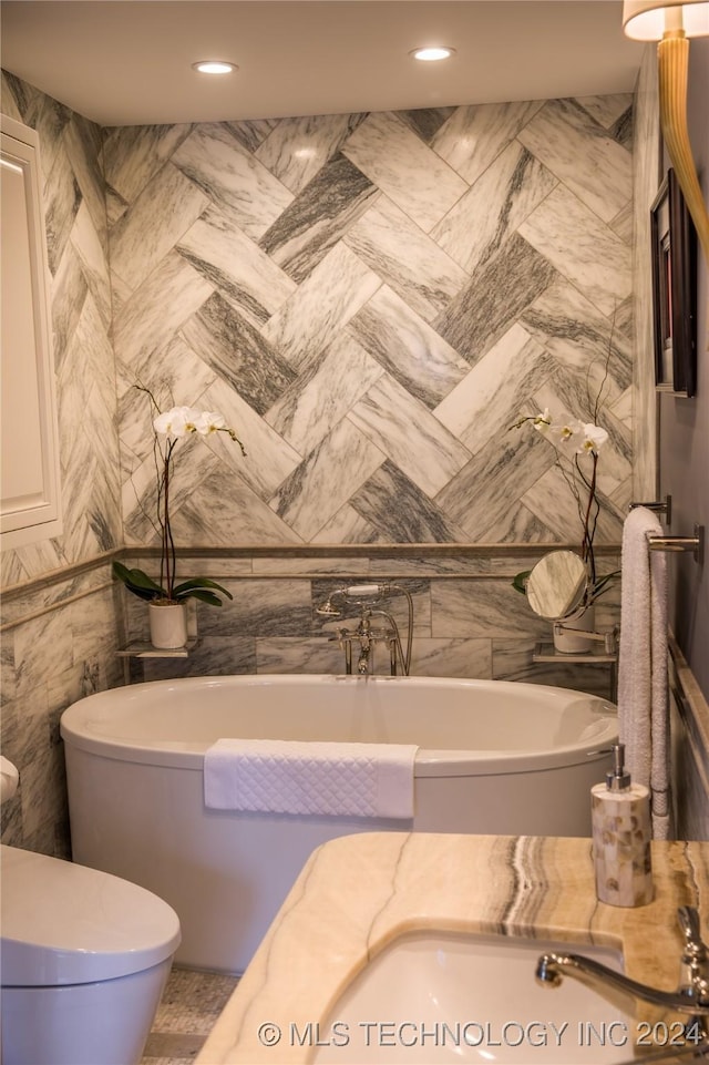 bathroom featuring a bathtub, tile walls, and toilet