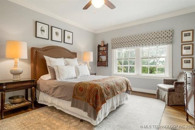 bedroom featuring ceiling fan, crown molding, and light wood-type flooring